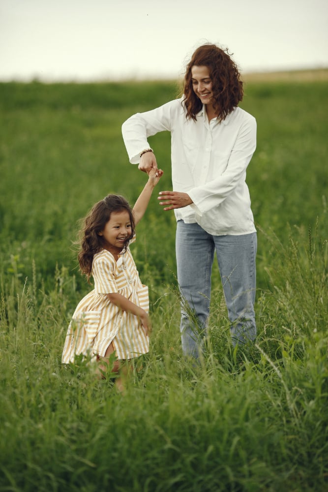 mother-with-daughter-playing-summer-field