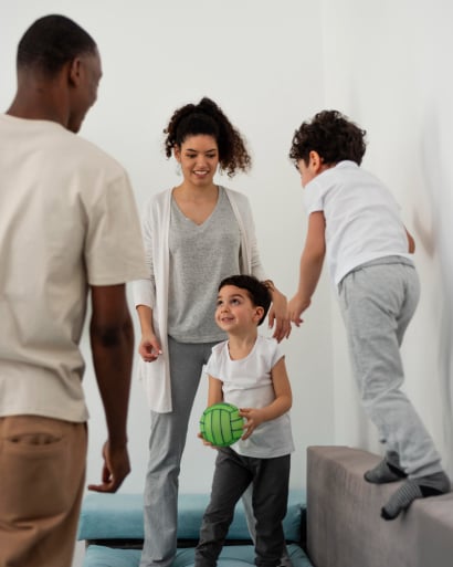 young-family-having-fun-while-playing-with-ball